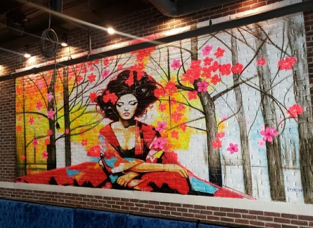 Mural Art of Woman Wearing Traditional Japanese Clothing Around Cherry Blossoms.